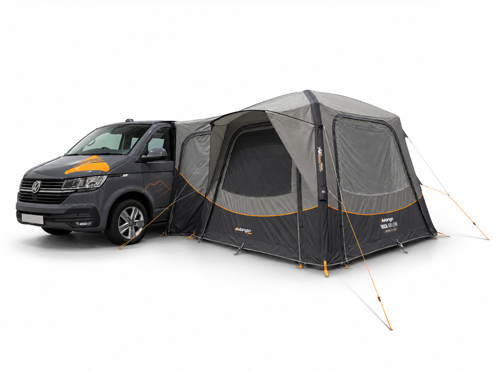 Grey Vango Roca Air Low driveaway awning attached to a dark grey campervan, with windows and guy lines visible.