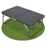 Quest Superlite Witney low folding camping table with black tabletop and legs extended on grass