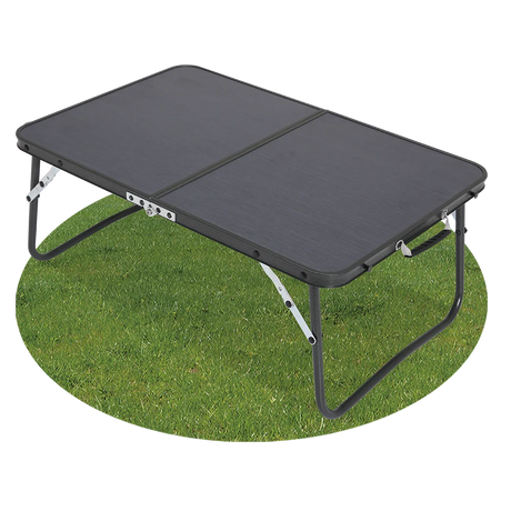 Quest Superlite Witney low folding camping table with black tabletop and legs extended on grass