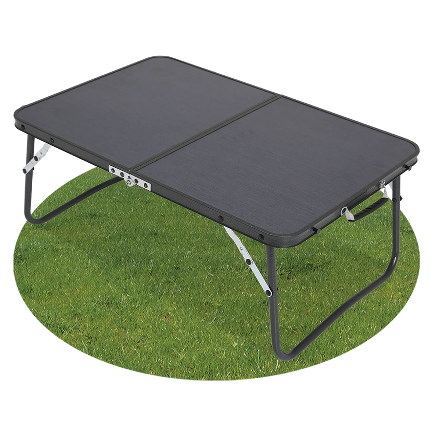 Quest Superlite Witney low folding camping table with black tabletop and legs extended on grass